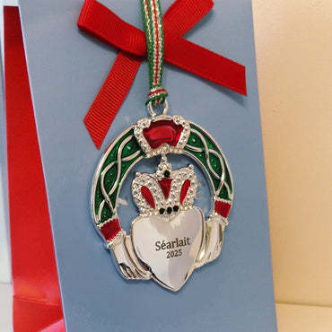 Decorative ornament with a red ribbon on a blue card