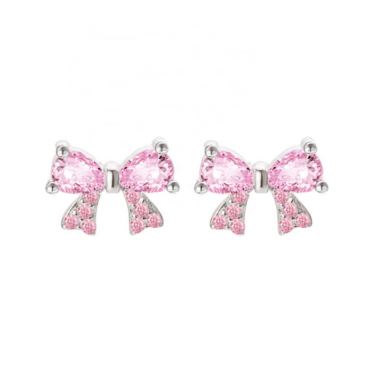 Pink bow-shaped earrings with clear gemstones on a white background