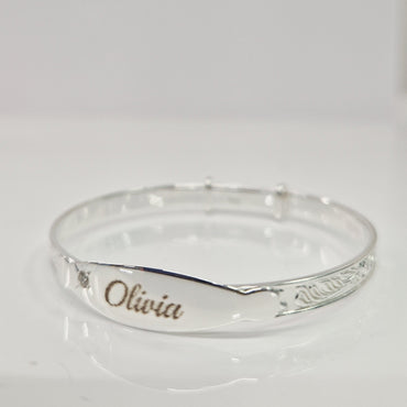 Baby bangle with laser engraving on a white background