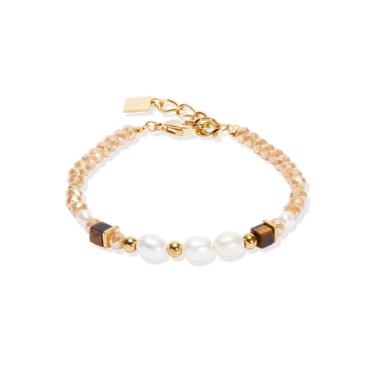 Bracelet with gold, brown, and pearl beads on a white background