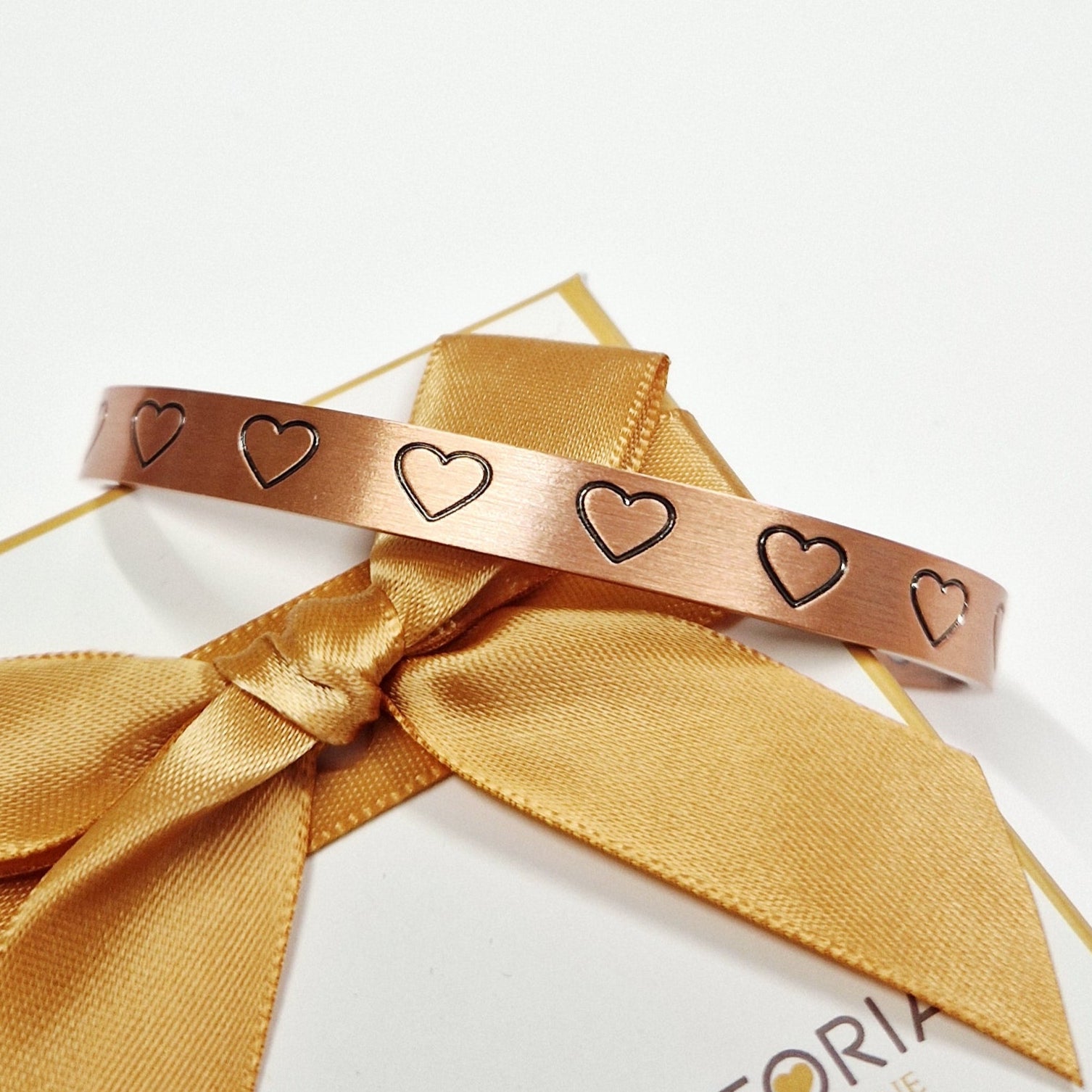 close up of magnetic hearts bangle for women