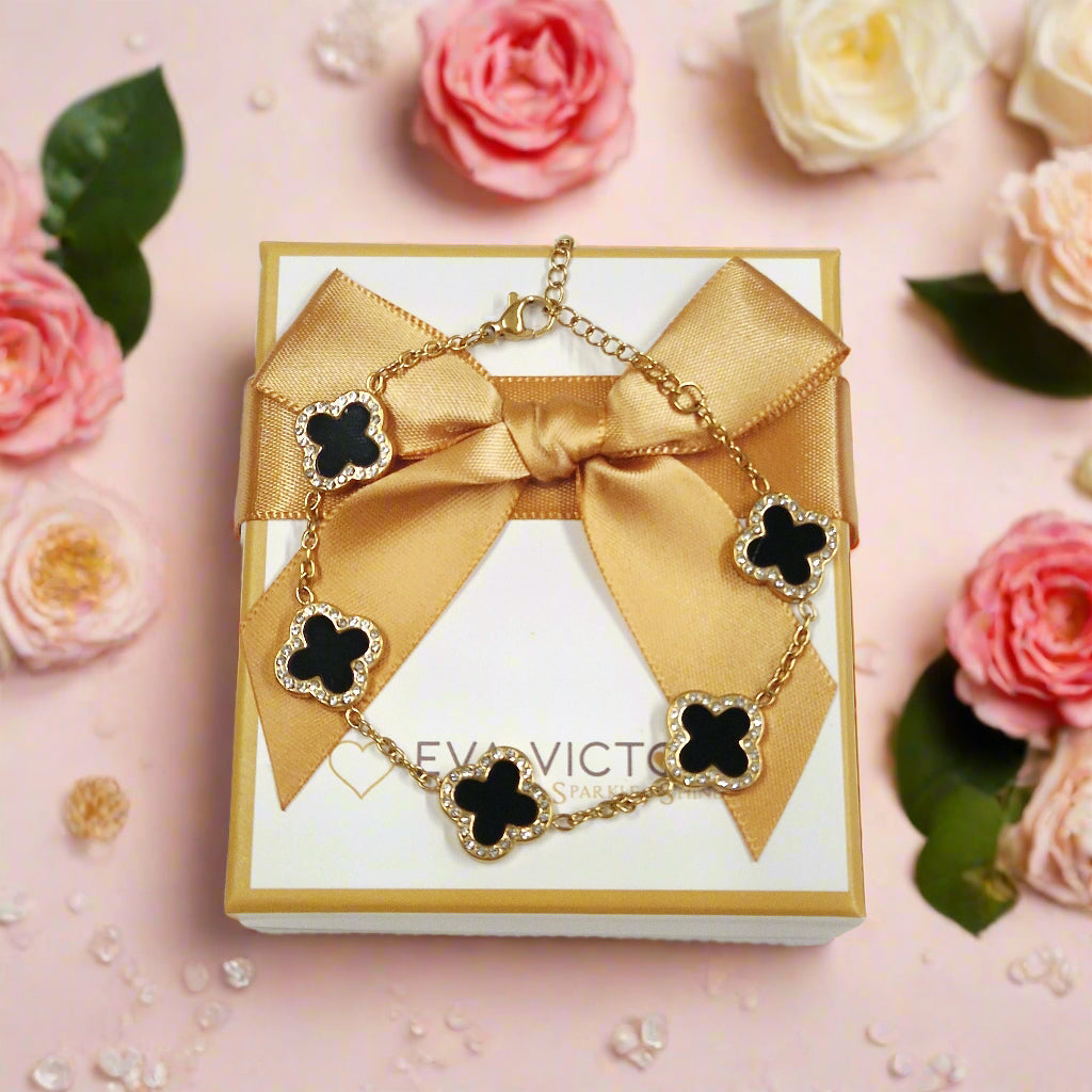 Gold bracelet with black clover-shaped charms in eva victoria gift box