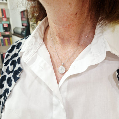 silver round locket with photos on model - eva victoria ireland