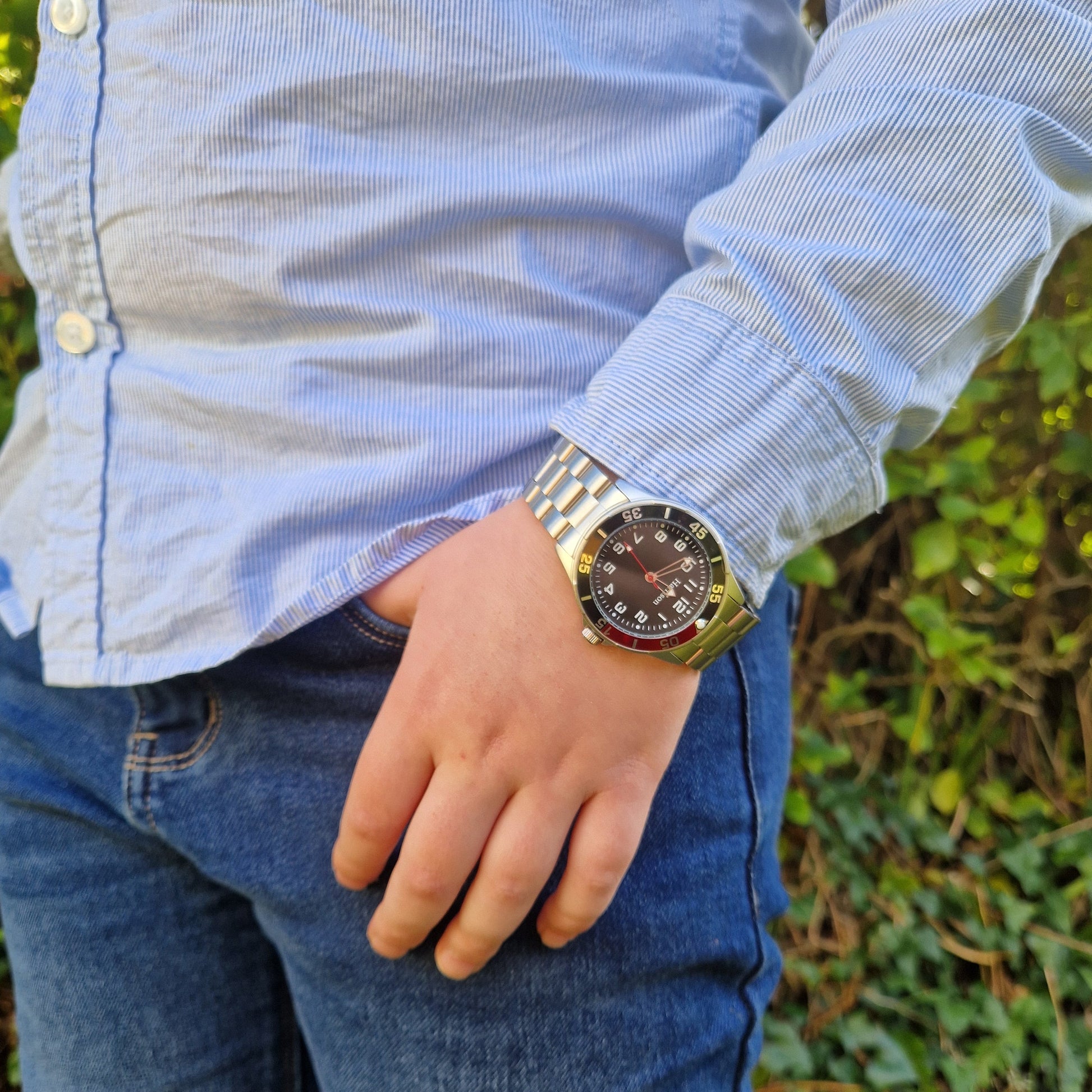 red black silver stainless steel watch on a model