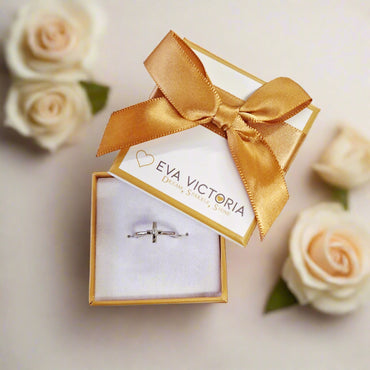 Jewelry box with a gold bow and sterling silver ring with holy cross for children communion