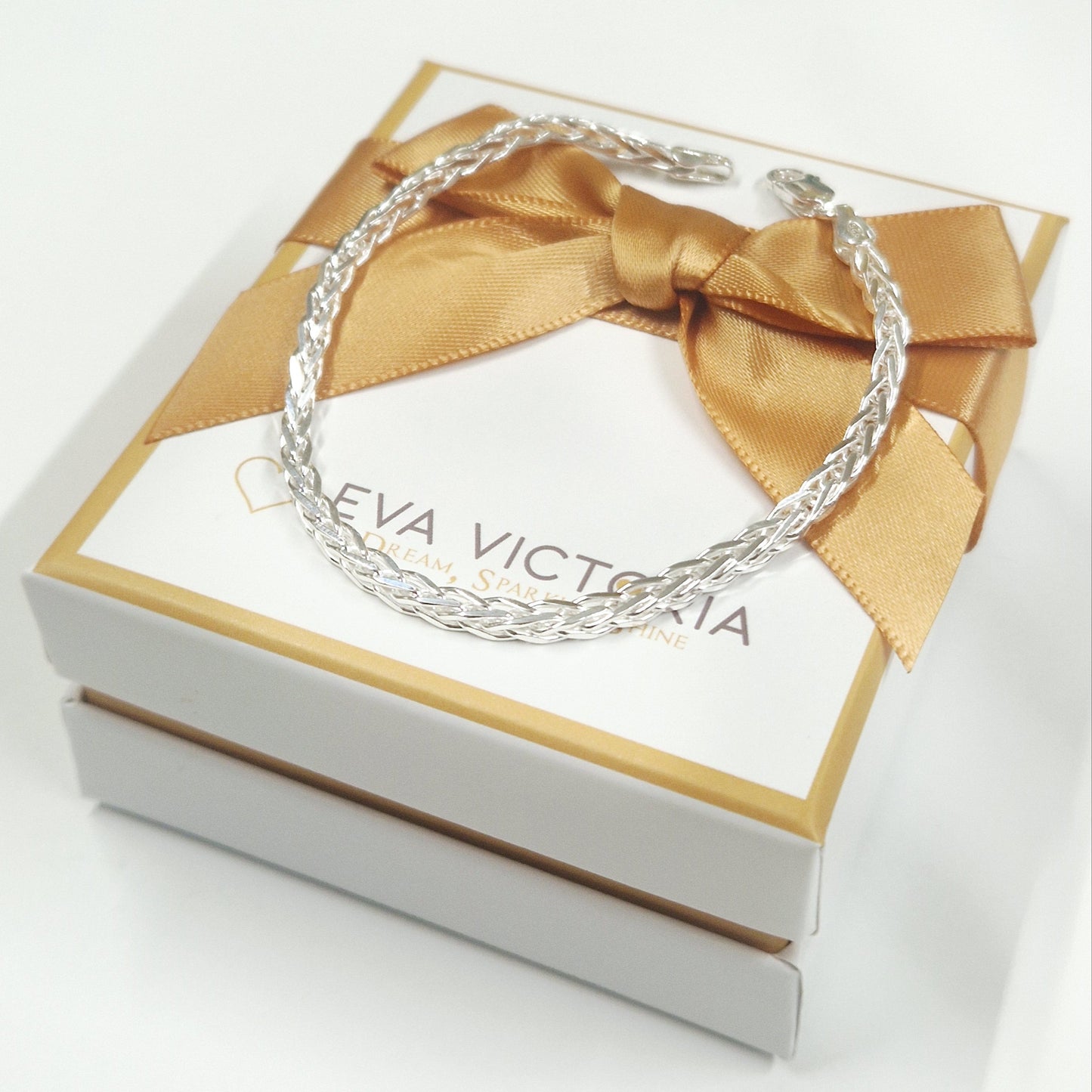 Sterling Silver spiga bracelet on a branded box with a gold ribbon