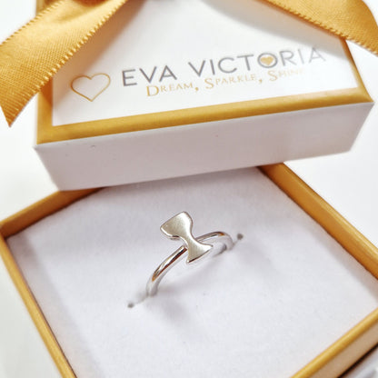 Silver chalice ring in a gold and white box with a gold bow, branded 'Eva Victoria'.