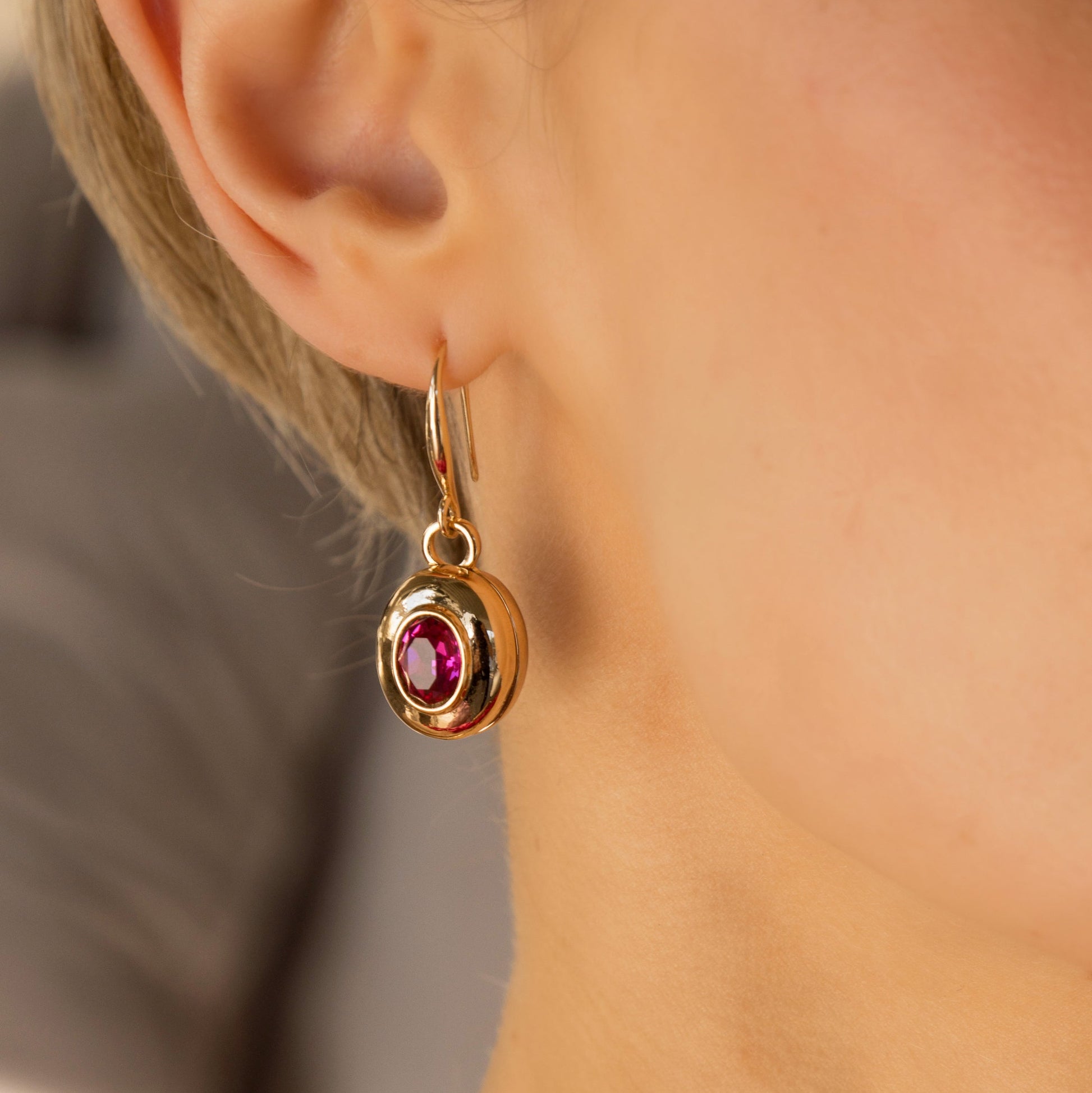 large gold and pink drop earrings on model