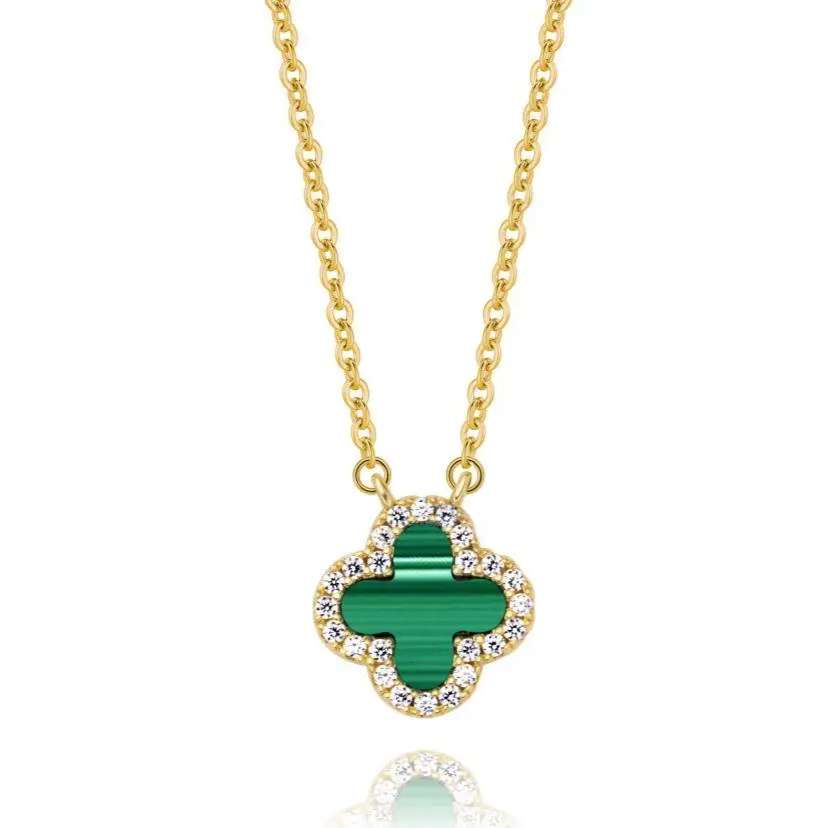 Gold necklace with a green clover pendant on a white background