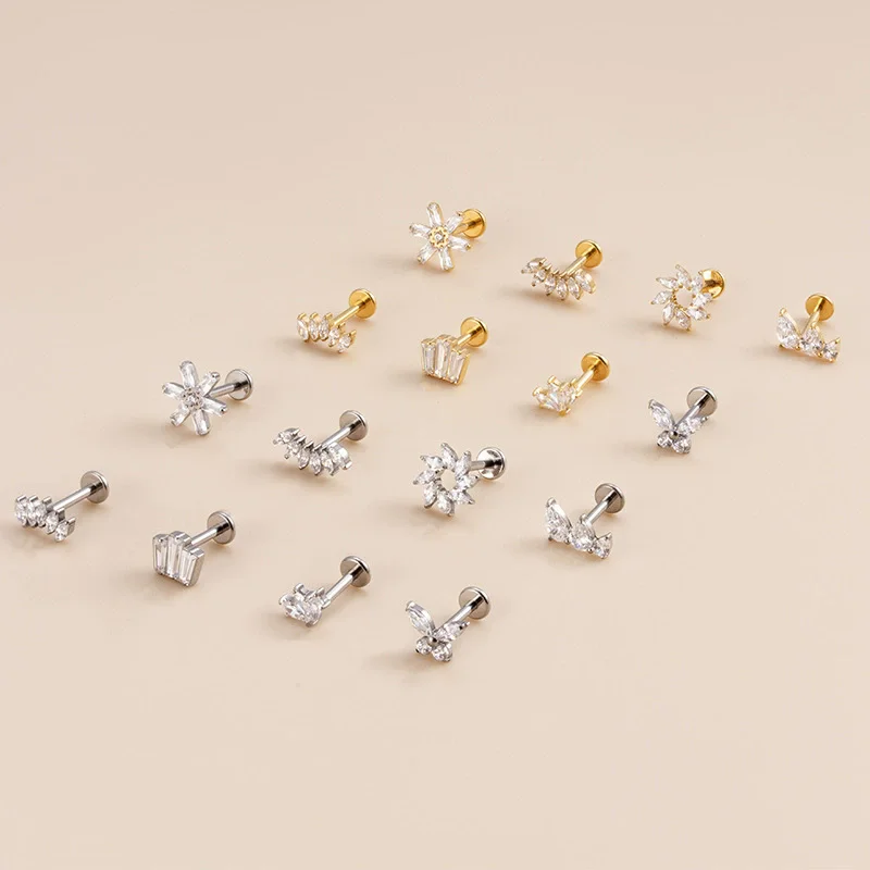 Collection of small earrings on a beige background
