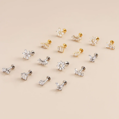 Collection of small earrings on a beige background