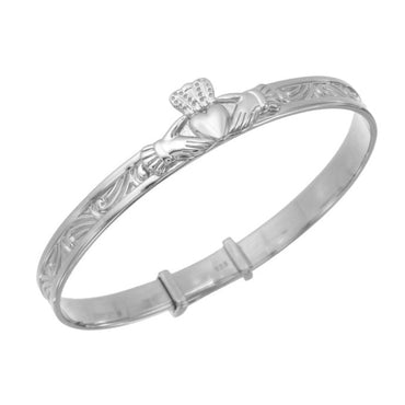 Silver baby bangle with claddagh design on a white background