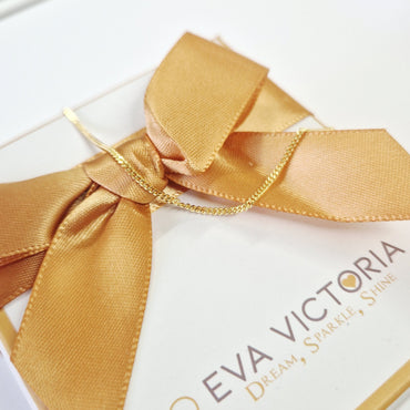 gold plated 1mm curb chain closeup on gift box