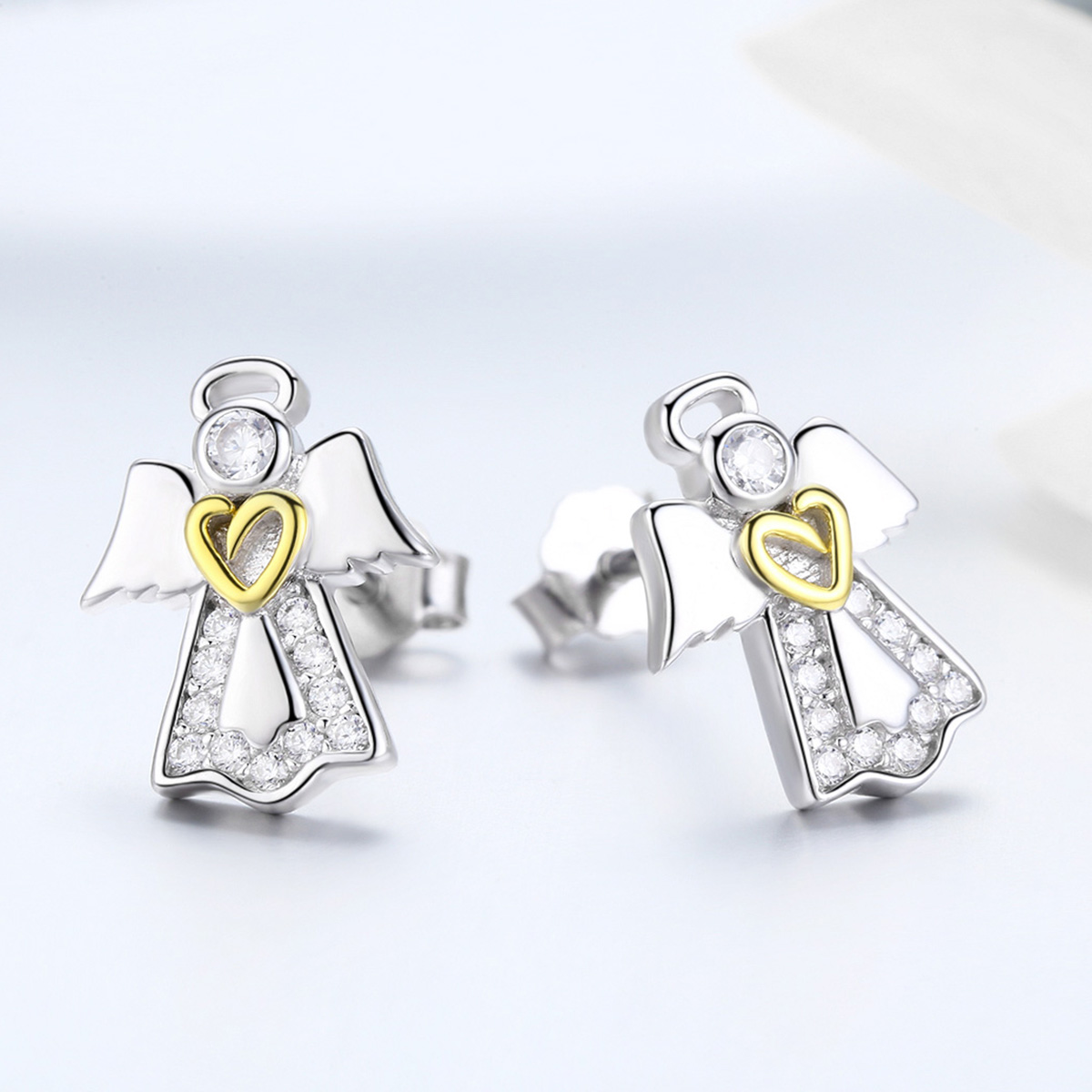 Silver angel earrings with gold hearts on a light gray background
