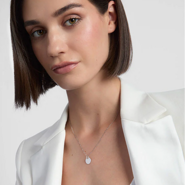 Woman wearing a necklace with a white background