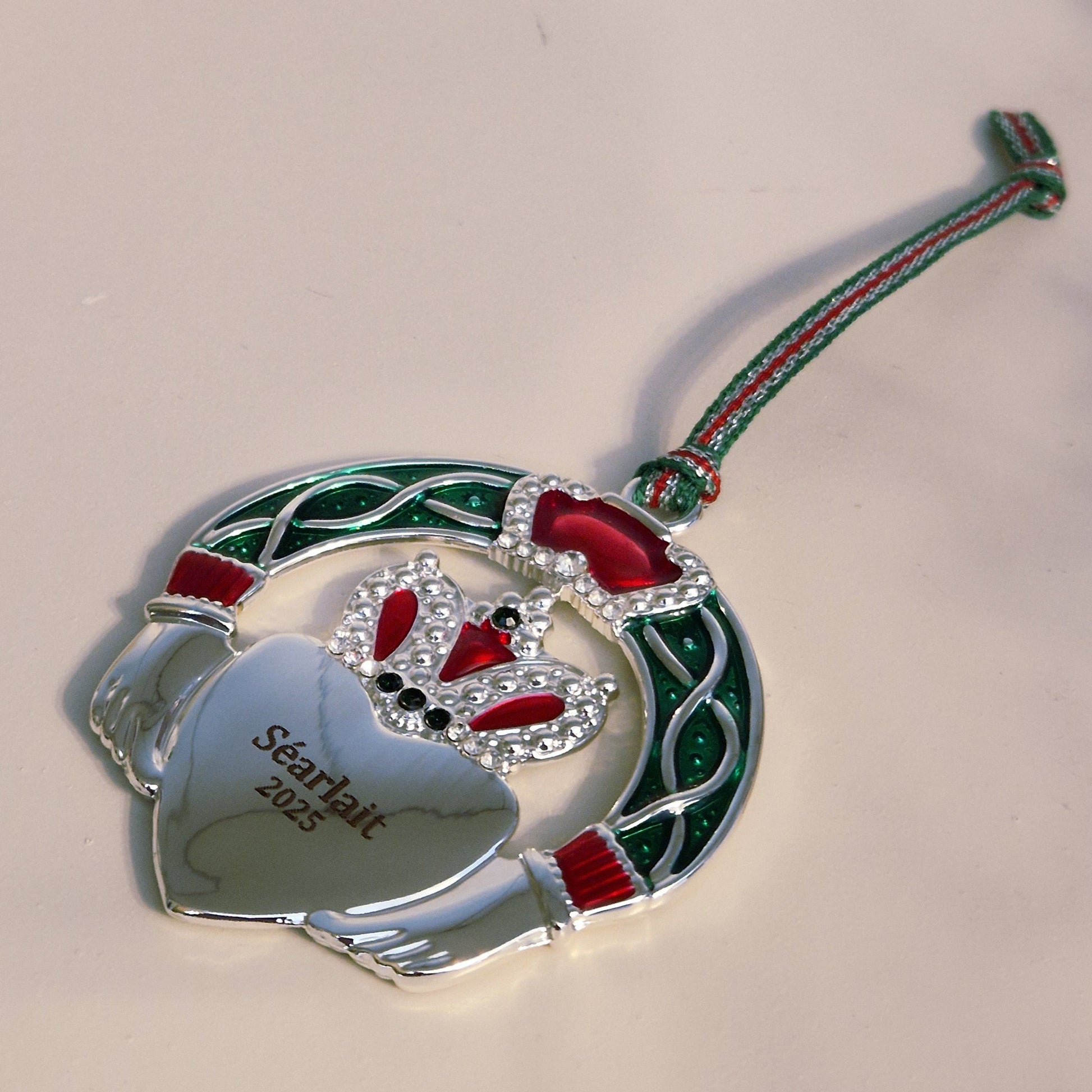 Decorative Christmas ornament with red and green accents on a white background