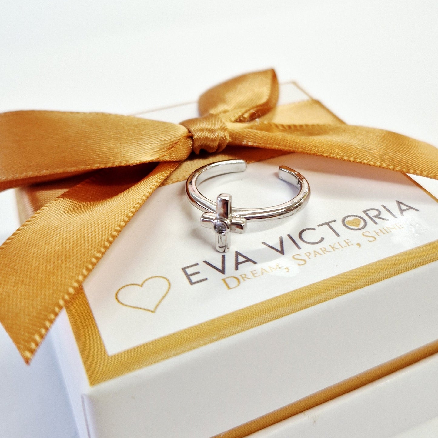 adjustable size silver ring for kids with 'Eva Victoria' branding on a white box with a gold ribbon.