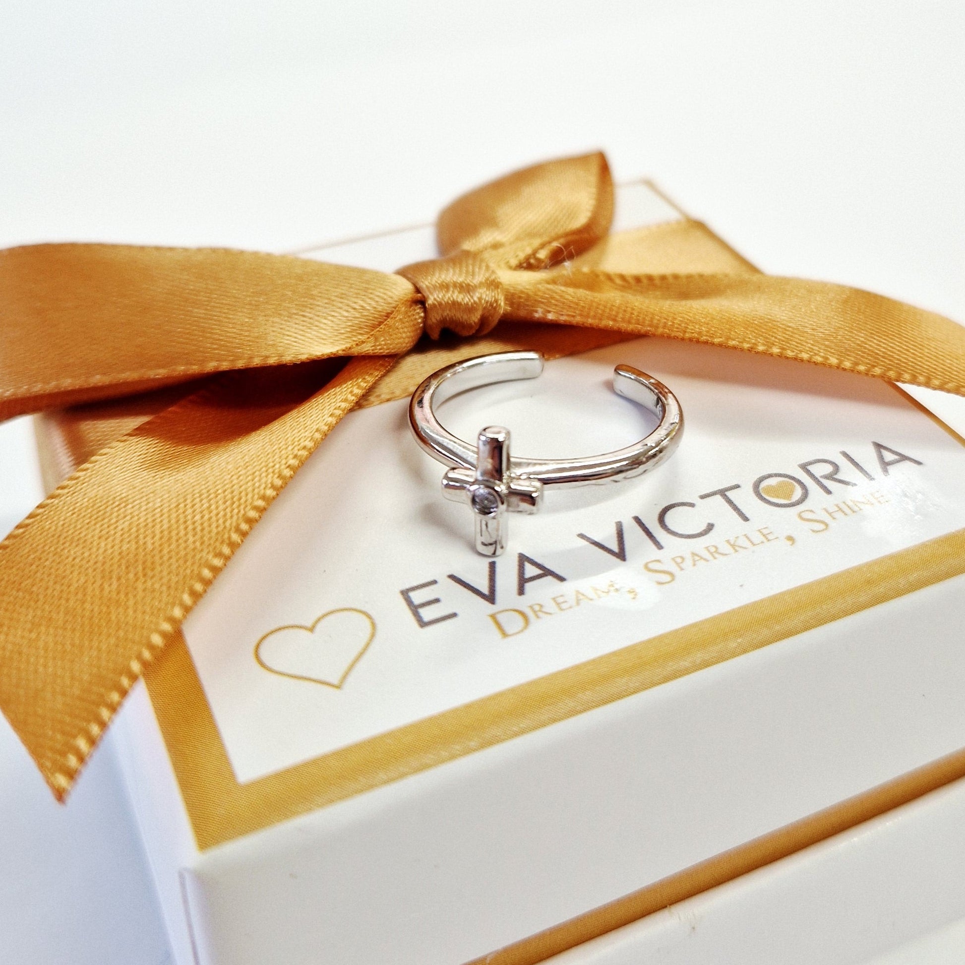 adjustable size silver ring for kids with 'Eva Victoria' branding on a white box with a gold ribbon.