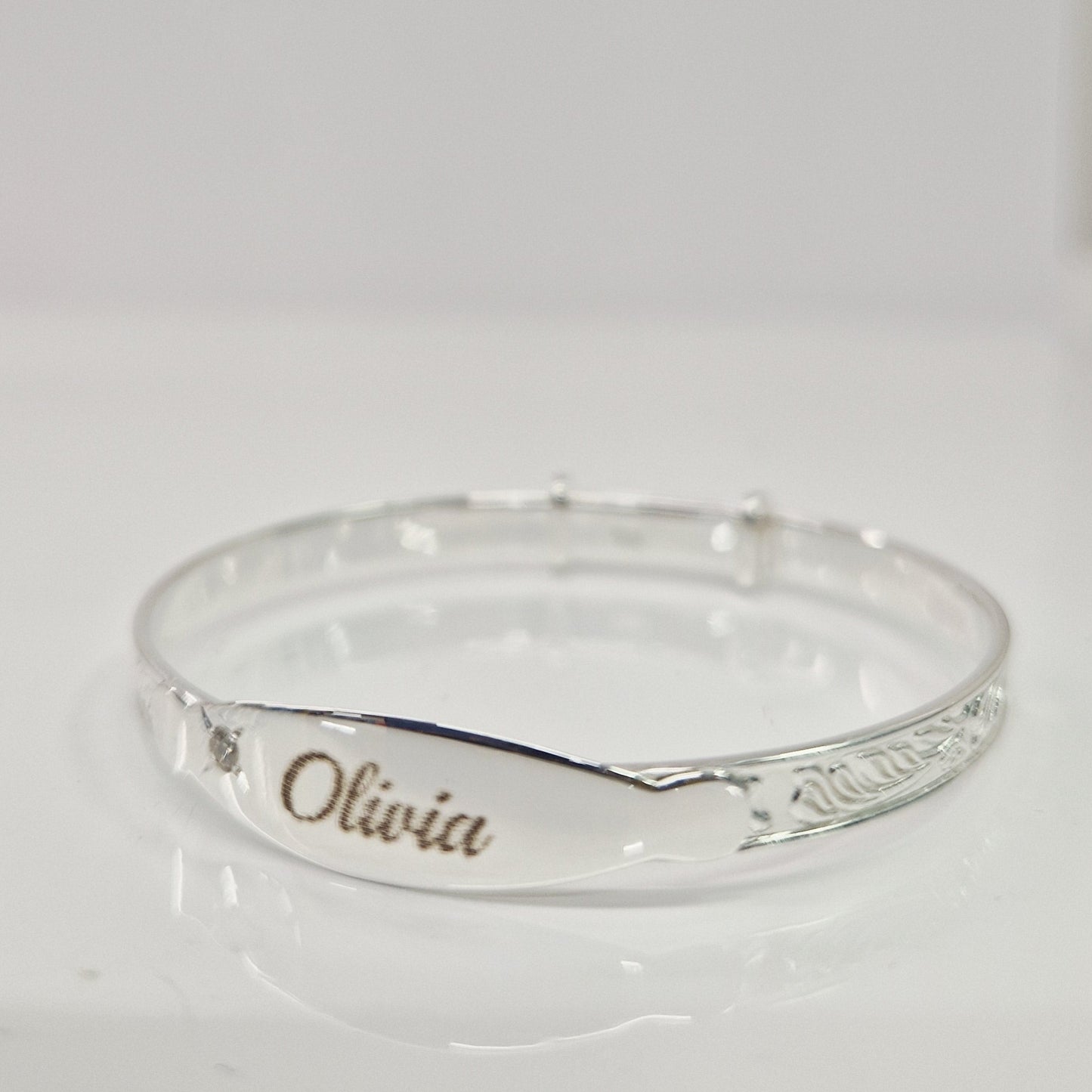 Baby bangle with laser engraving on a white background