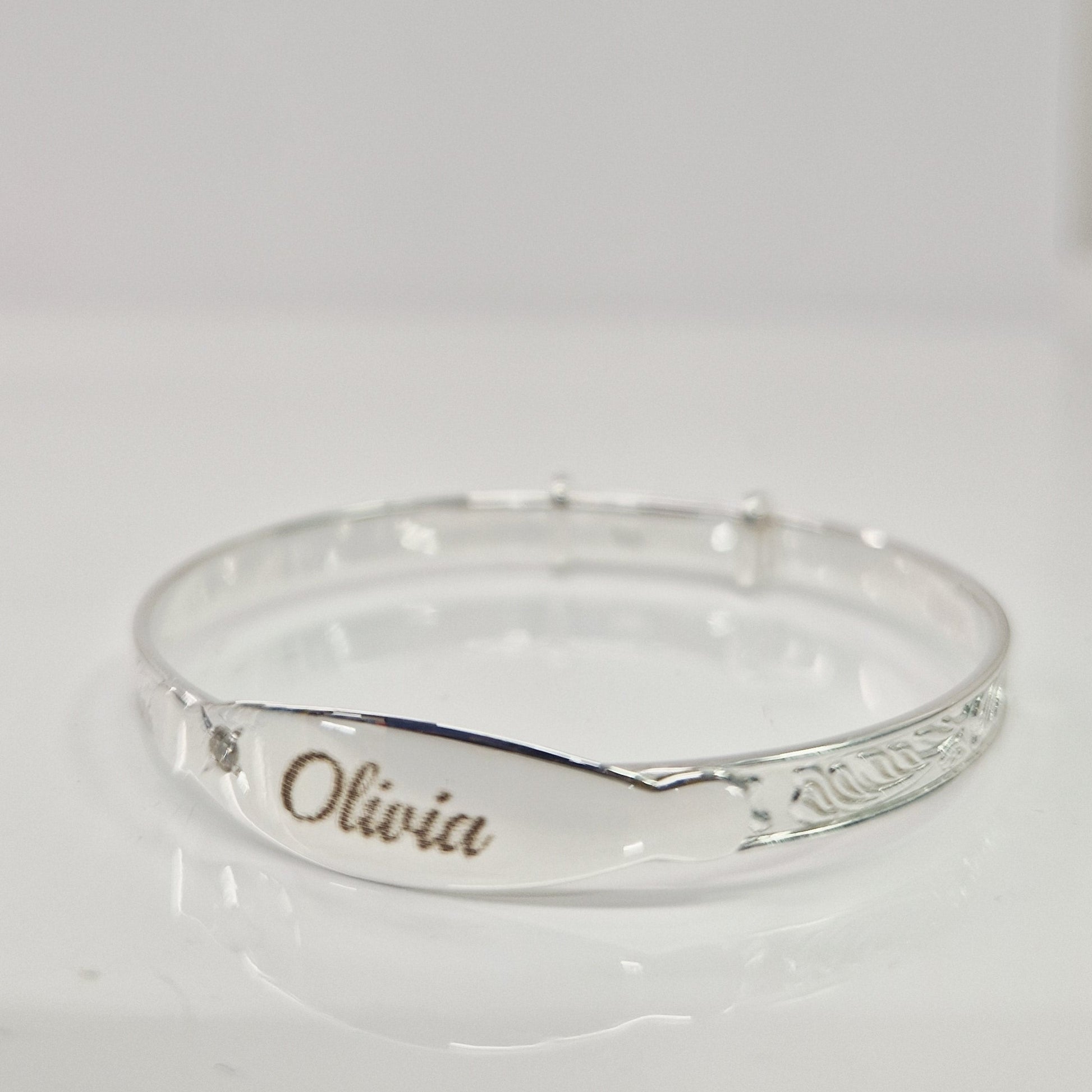 Baby bangle with laser engraving on a white background
