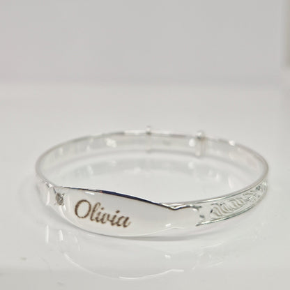 Baby bangle with laser engraving on a white background